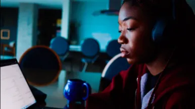 Student looking at a computer with blue background